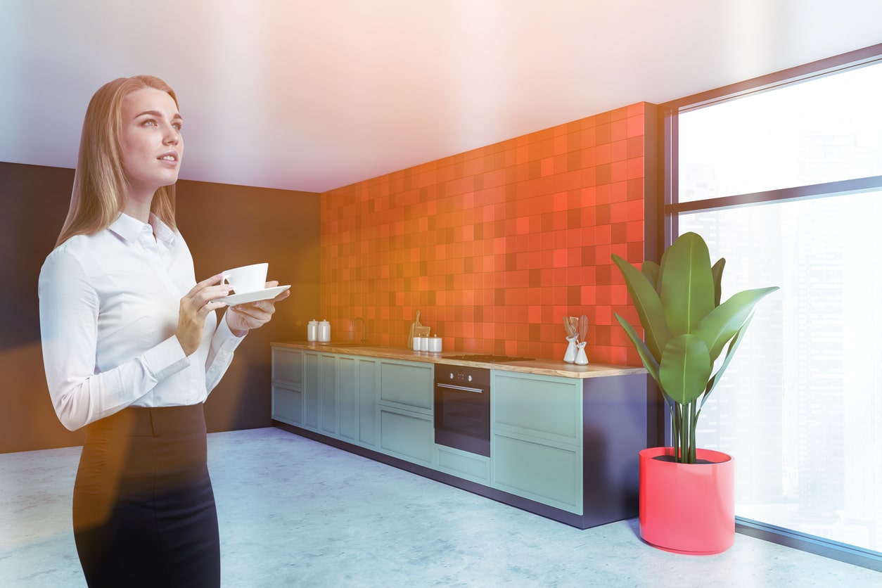 Blonde woman in red kitchen with blue counters